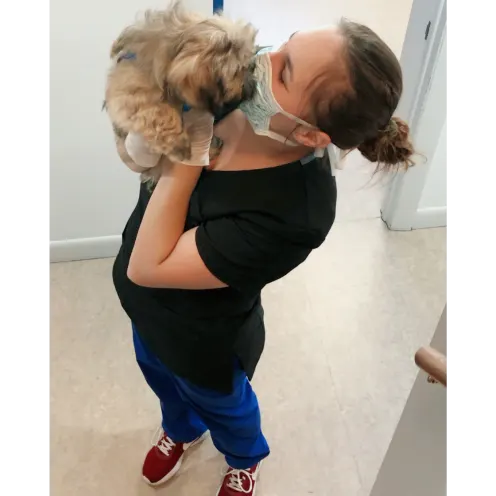 Staff Member Kissing a Dog